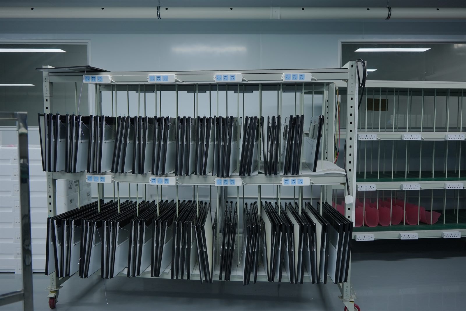 Monitor panels stored on organized factory racks